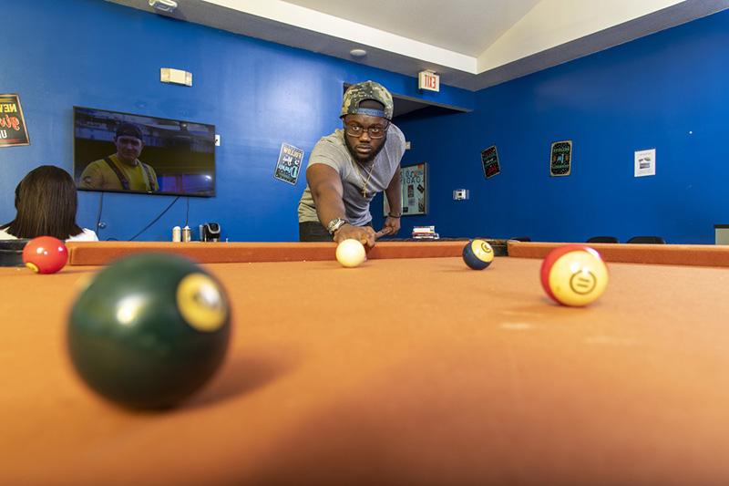 Resident playing pool